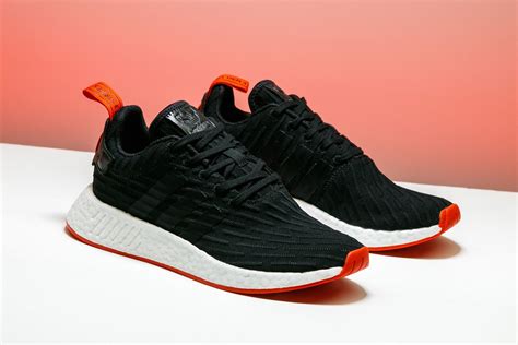 A sleek striped motif appears on this adidas NMD_R2 in black from the ...