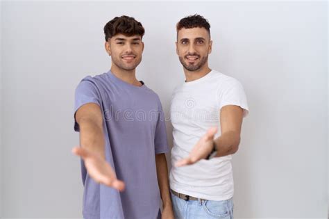 Homosexual Gay Couple Standing Over White Background Smiling Cheerful Offering Palm Hand Giving