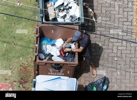 A Poor Man Digging Through The Trash Stock Photo Alamy