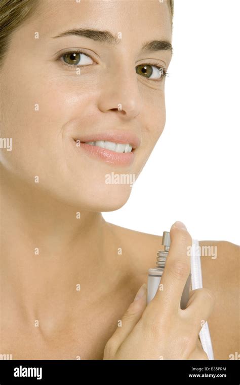 Woman Spraying Perfume On Her Neck Smiling At Camera Stock Photo Alamy