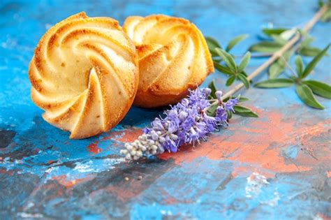 Free Photo Front View Biscuits Purple Flowers On Blue Table
