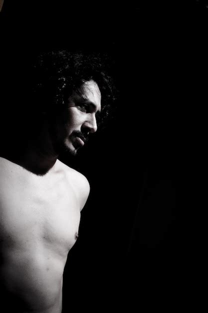 Premium Photo Shirtless Mature Man Standing Against Black Background