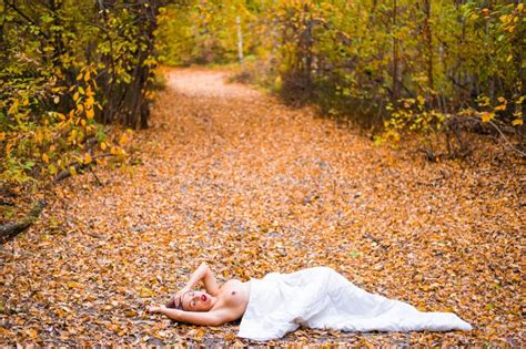 Caucasian Woman Lies In The Autumn Forest Under A Blanket Nude Girl In A Leaf Fall Stock Photo