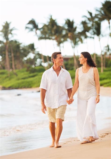 Mature Couple Walking On The Beach At Sunset Stock Photo Image Of Retirement Active