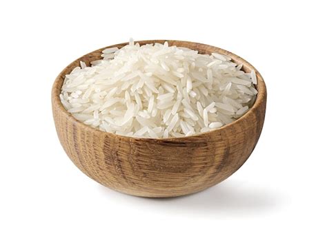 Premium Photo Dry White Long Rice Basmati In Wooden Bowl Isolated On