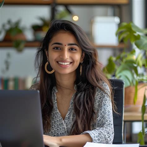 Premium Photo A Woman Sits At A Desk In Front Of A Laptop