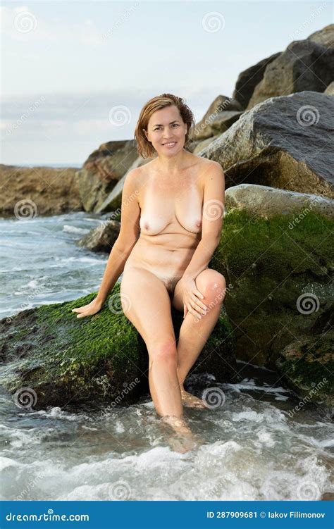 Portrait Of Nude Woman Lying On Stones At Sea Shore Stock Image Image Of American Coast