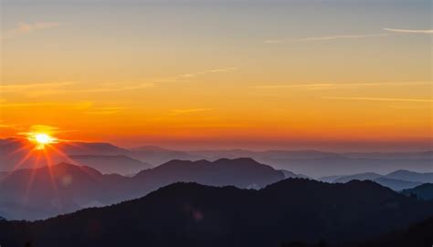 Premium AI Image | Beautiful sunrise over the mountain range in the fog