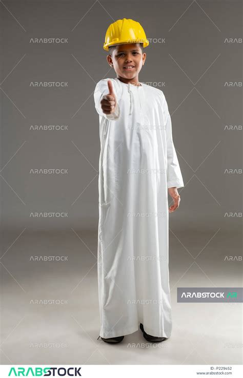 Portrait Of An Arab Gulf Omani Boy Wearing A Dishdasha And A Thobe