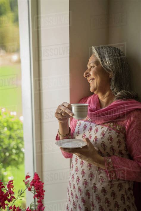Mature Woman At Window With Tea Cup Royalty Free Stock Photo Dissolve