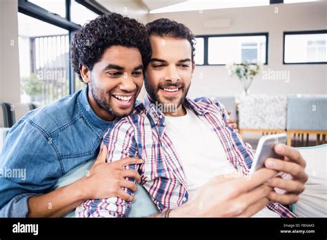 Happy Gay Couple Using Smartphone Stock Photo Alamy
