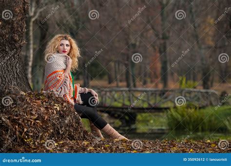 Beautiful Woman Posing In Park During Autumn Season Blonde Girl Wearing Green Blouse And Big