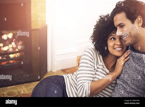 Its Getting Hot In Here An Affectionate Couple Relaxing By The Fireplace In Their Living Room