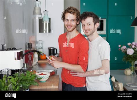 Portrait Of Loving Gay Couple In Kitchen Stock Photo Alamy