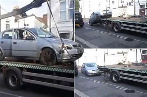 Watch Motorist Trying To Escape Parking Rap By Reversing Car Off Tow