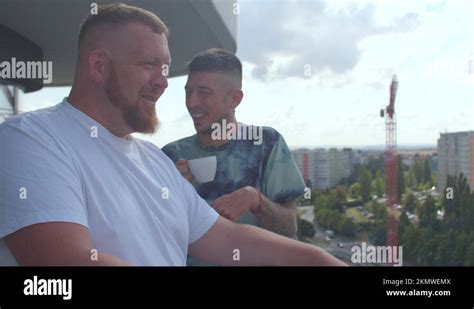 Two Gay Men Talking On Terrace House He Smokes Cigarette Friends Communication Stock Video