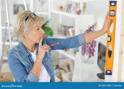 Mature Woman Using Spirit Level In Home Stock Image Image Of Accuracy