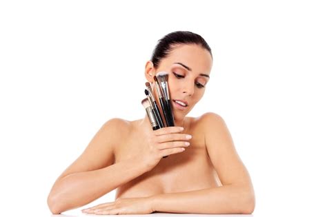 Premium Photo Beautiful Naked Woman Holding Make Up Brushes Against White Background