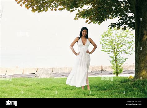 A Moment Of Tranquility Dark Complexioned Latina Woman Takes A Calming Walk By The Tree Lined