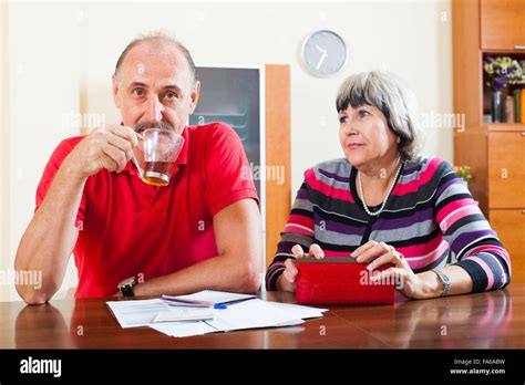 Financial Problems Mature Woman Asks For Money From Her Husband For The Credit Stock Photo Alamy