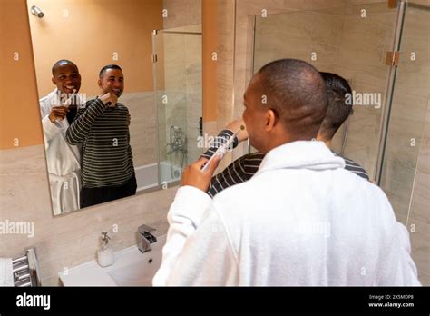 Uk London Smiling Gay Couple Brushing Teeth In Bathroom Stock Photo Alamy