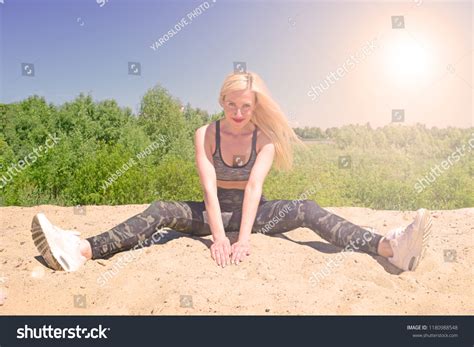 Sporty Blonde Girl Sitting On Sand Stock Photo 1180988548 Shutterstock