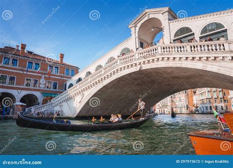 Iconic Rialto Bridge Spanning The Grand Canal In Venice, Italy Amidst Bustling Cityscape ...