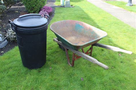 Lot 199 Rubbermaid Bruiser Garbage Can And Wheel Barrow Needs Tlc