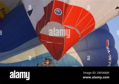 A Man Lifts Up A Huge Balloon At A Balloon Festival Blowing Up Hot Air Balloons Flame Rising