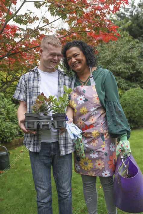 Smiling Mature Mother With Adult Son Standing In Garden Stock Image F044 4638 Science
