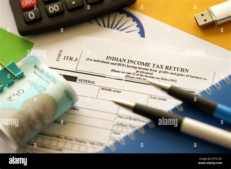 Indian Income Tax Return Blank Form With Pen And Indian Rupees Bills On