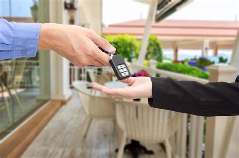Premium Photo Cropped Hand Of Salesman Giving Car Key To Customer
