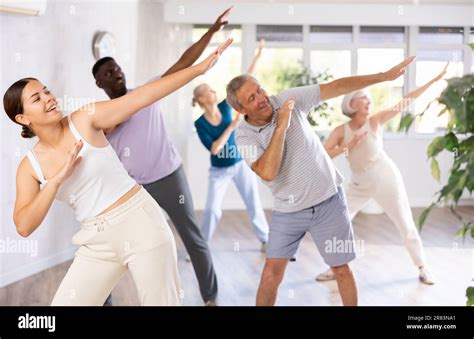 Female Instructor Teaches Mature Students Of Dance Class Basic Movements Of Hip Hop Dance Stock