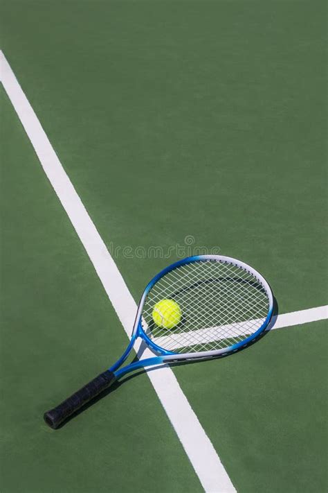 Photo Of Tennis Racket Tennis Ball On Court Background Stock Image