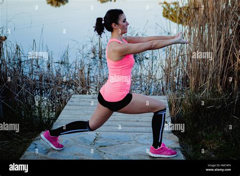 Brunette Athlete Doing Stretching Exercise In Nature Stock Photo Alamy