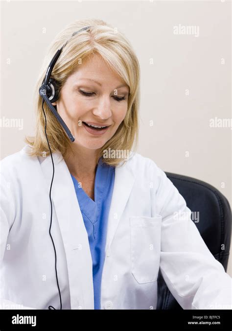 Mature Woman Talking On Headset Studio Shot Stock Photo Alamy
