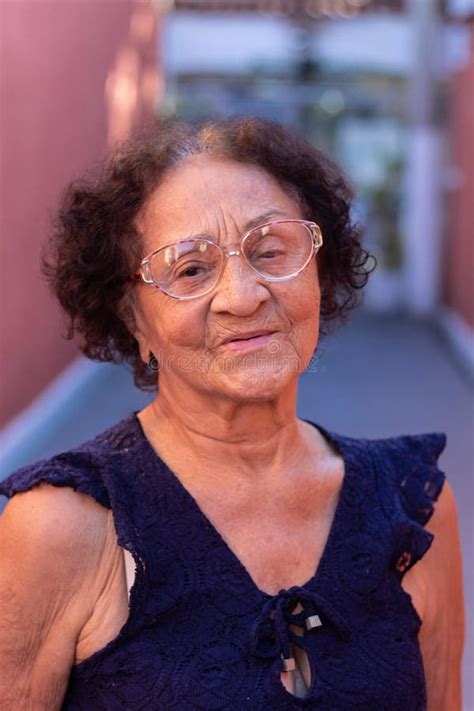 Mature Brazilian Man In Formal Wear Celebrating With His Smartphone And Clenched Fist Blue