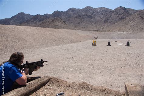 Firing an AR-15 assault rifle with grenade launcher on a shooting range in the desert of Nevada ...