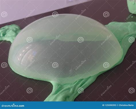 Creating A Large Bubble From Bright Green Slime Stock Image Image Of