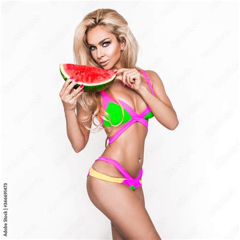 Elegant Sexy Woman In The Colorful Bikini On The Sun Tanned Slim And Shapely Body Is Posing On