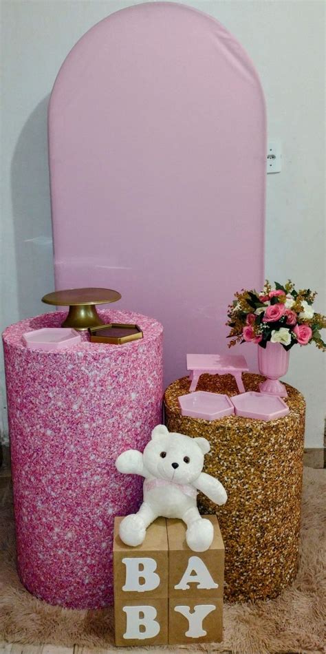 There Is A Teddy Bear Sitting On Top Of The Baby Blocks Next To Two Vases