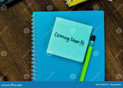 Concept Of Coming Soon Write On Sticky Notes Isolated On Wooden