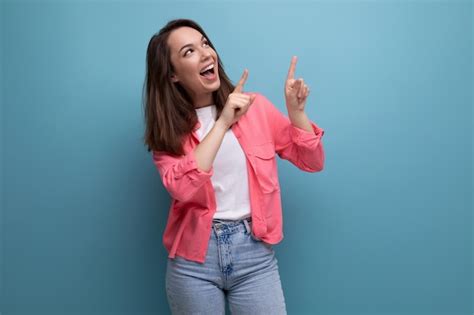 Premium Photo Happy Lucky Brunette Woman In Informal Look Rejoices On Studio Background