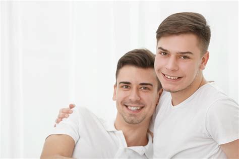 Premium Photo Happy Gay Couple Sitting Against Window