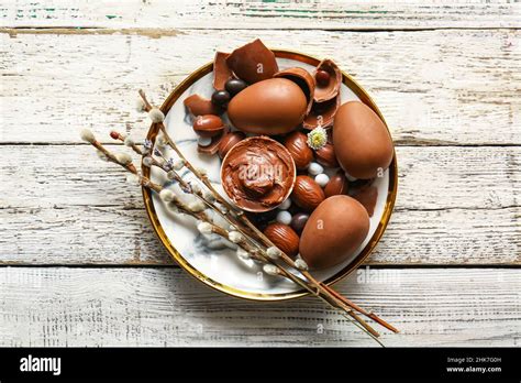 Plate With Chocolate Easter Eggs And Pussy Willow Branches On Light