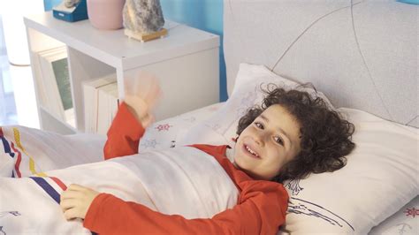 boy preparing  sleep   bed waving hand sleep time boy