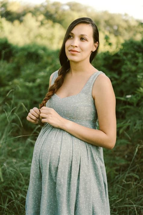 Portrait Of A Pregnant Brunette Woman With Long Hair Weaving A Braid Stock Image Image Of