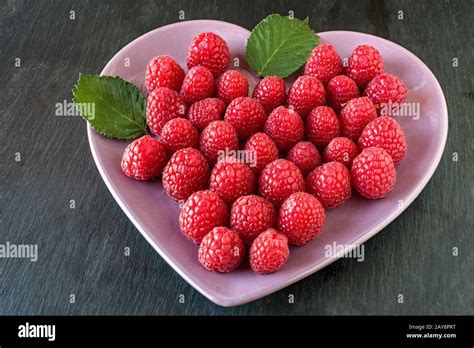 Raspberries In A Heart Shaped Bowl Stock Photo Alamy