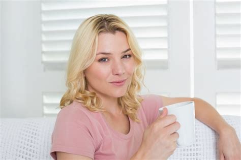 Premium Photo Happy Blonde Relaxing On The Couch With A Coffee