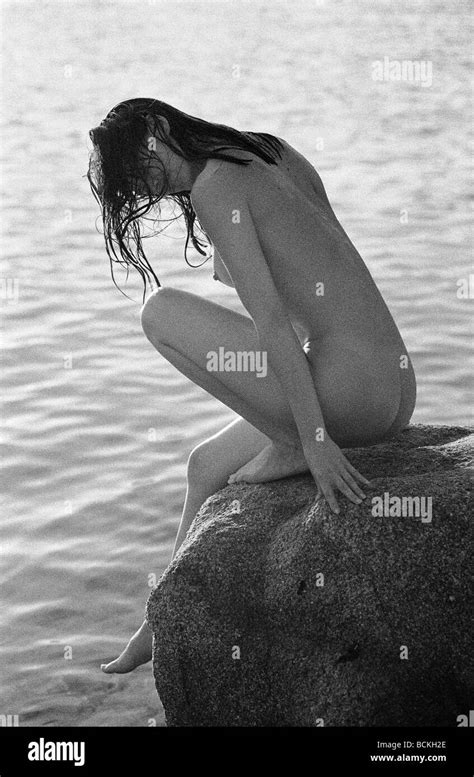 Nude Woman Sitting On Rock Next To Sea B W Stock Photo Alamy